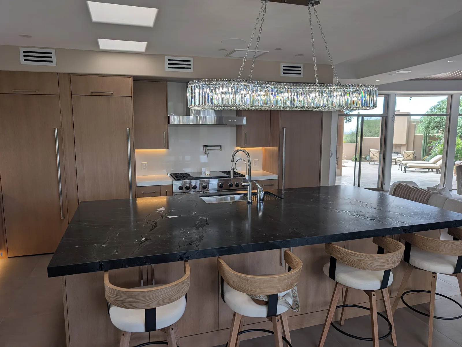 Dark stone kitchen island with an undermount sink in a Scottsdale residence